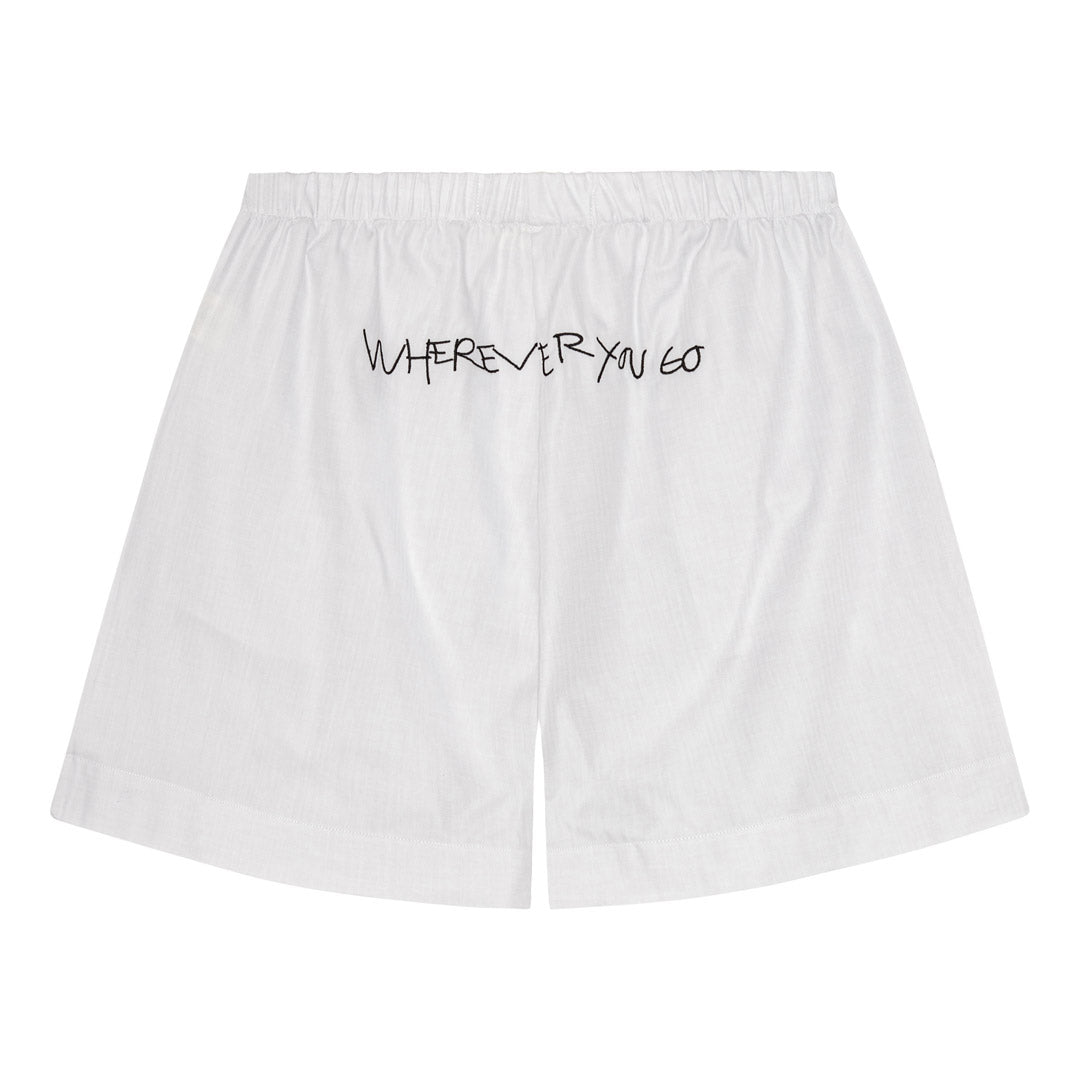 PILGRIM Shorts XS/S: Off-white cotton shorts with black handwritten text on the back, featuring a loose fit, elastic waist, button detail, and side pockets.