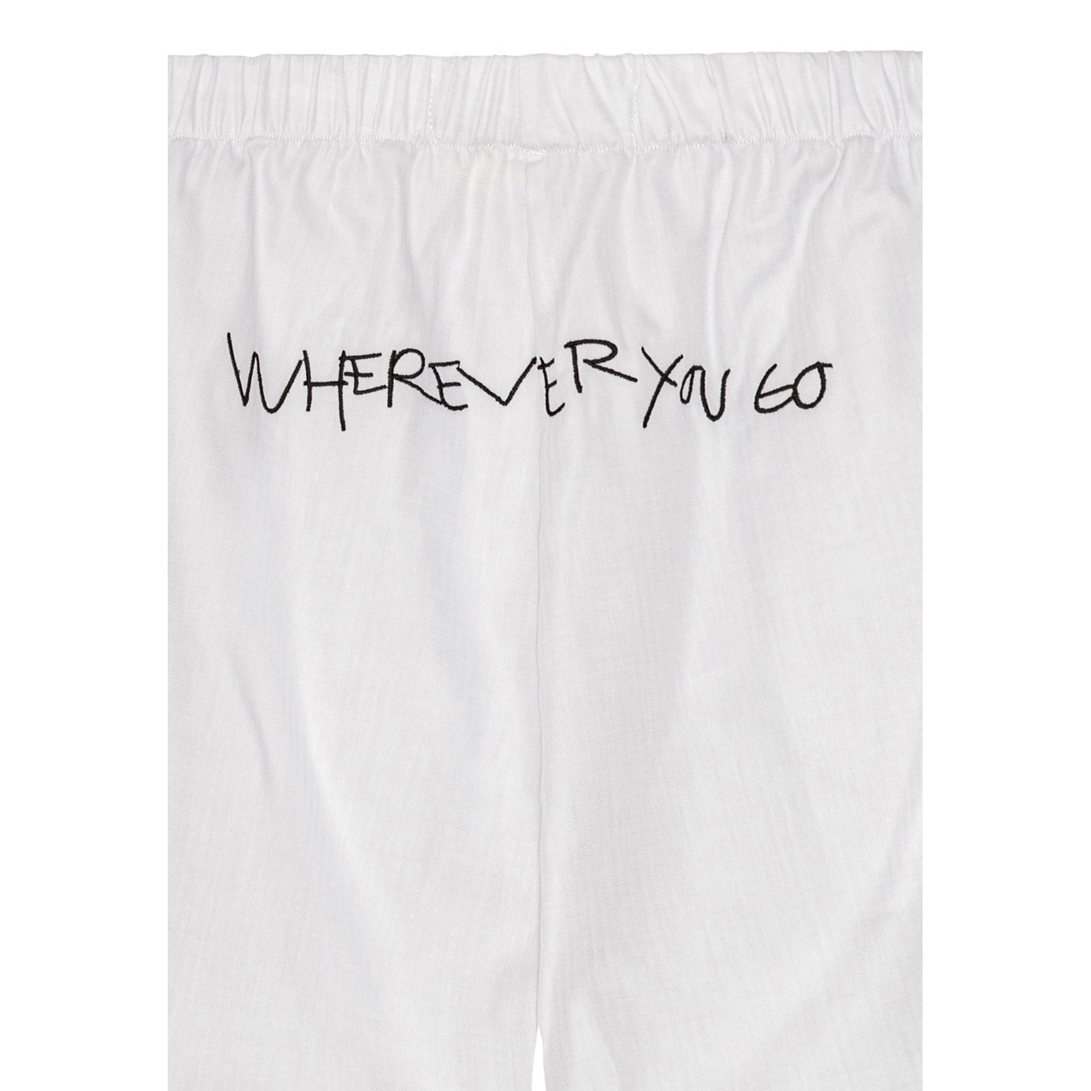Pilgrim's off-white Wherever you go shorts with black handwritten print, elastic waist, and side pockets. Ideal for comfort and adventure.