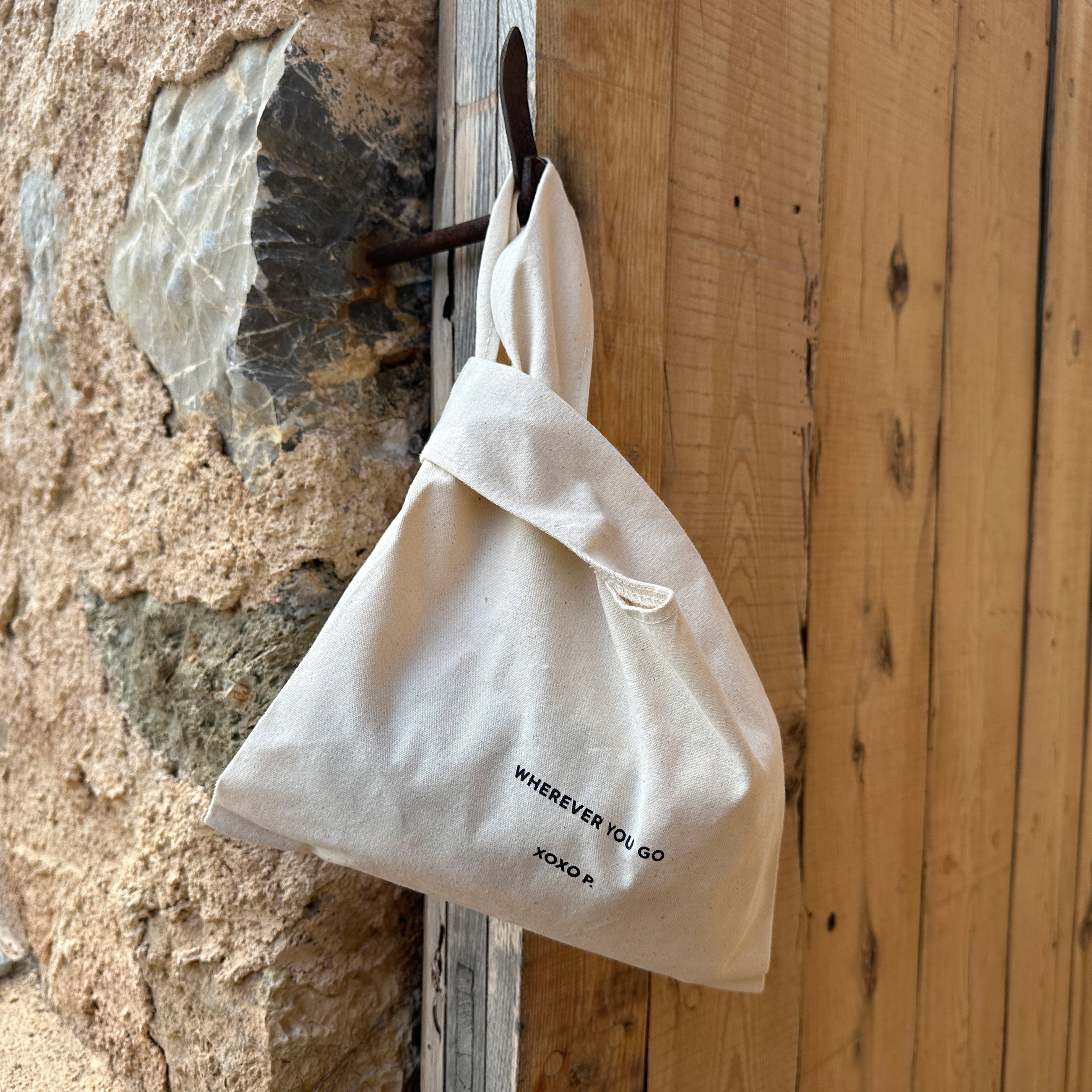 Close-up of the Small Fashion canvas tote-bag in off-white, featuring broad woven straps and wherever you go print, embodying Pilgrim's minimalist and sustainable design.