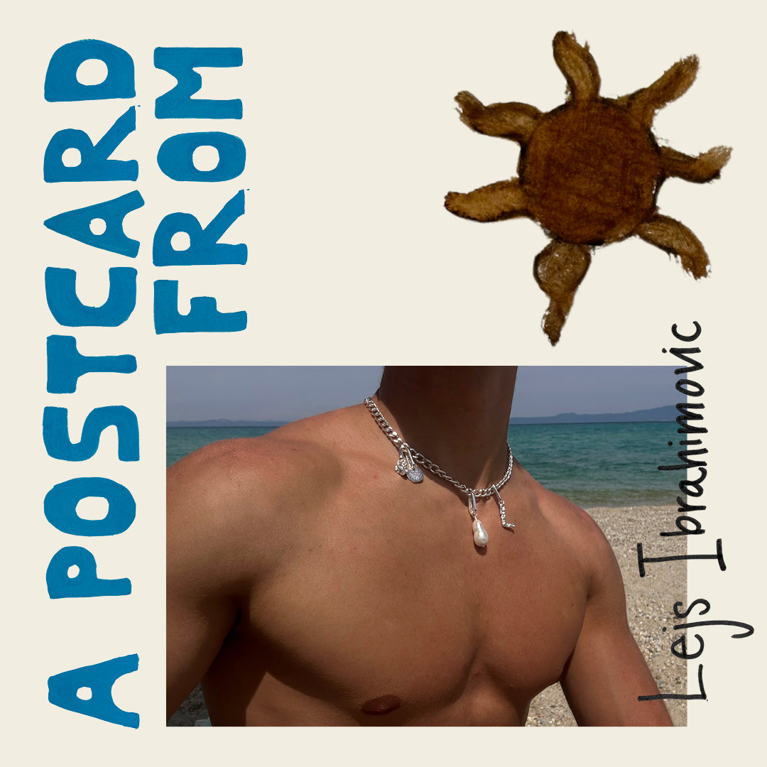A man on a beach wearing a stylish necklace, showcasing Pilgrim's blend of timeless and trendy Scandinavian jewellery design.