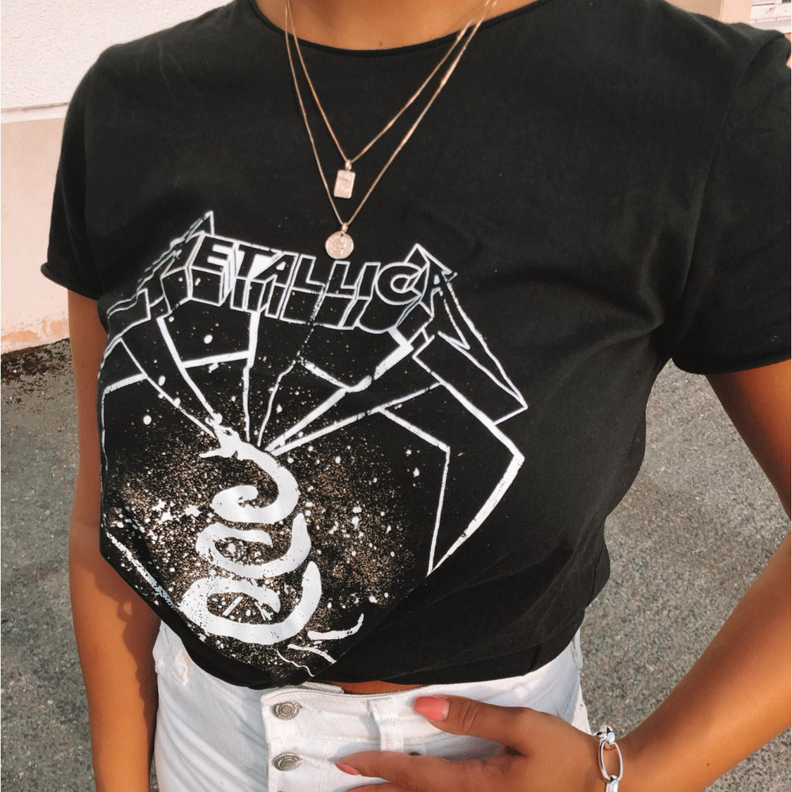 VALKYRIA coin necklace 2-in-1-set gold-plated featuring serpent and raven charms inspired by Norse mythology, worn by a woman in a black shirt.