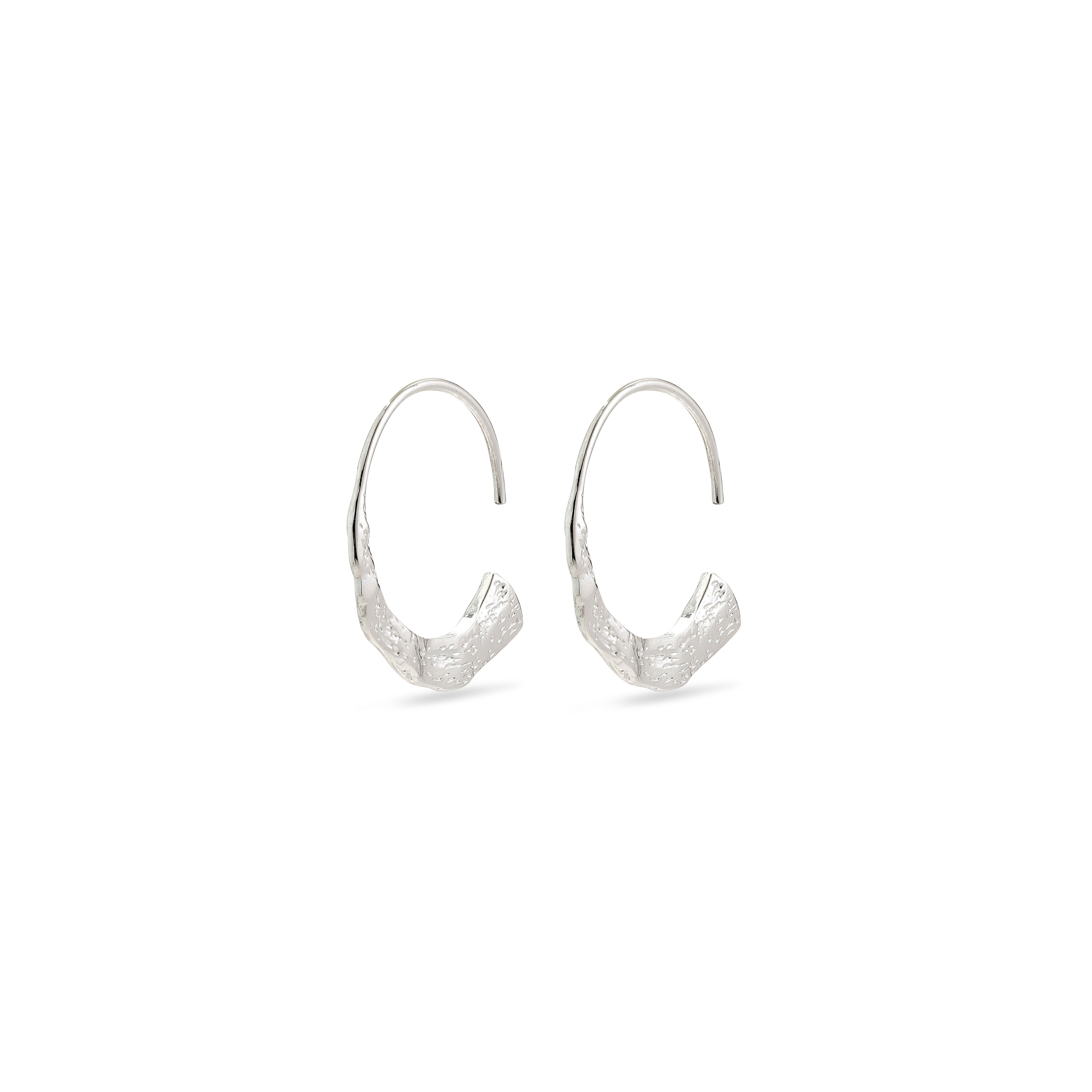 VALKYRIA silver-plated hoop earrings featuring a polished narrow ring that widens into a flat, hammered semicircle, inspired by the rugged Nordic landscape.