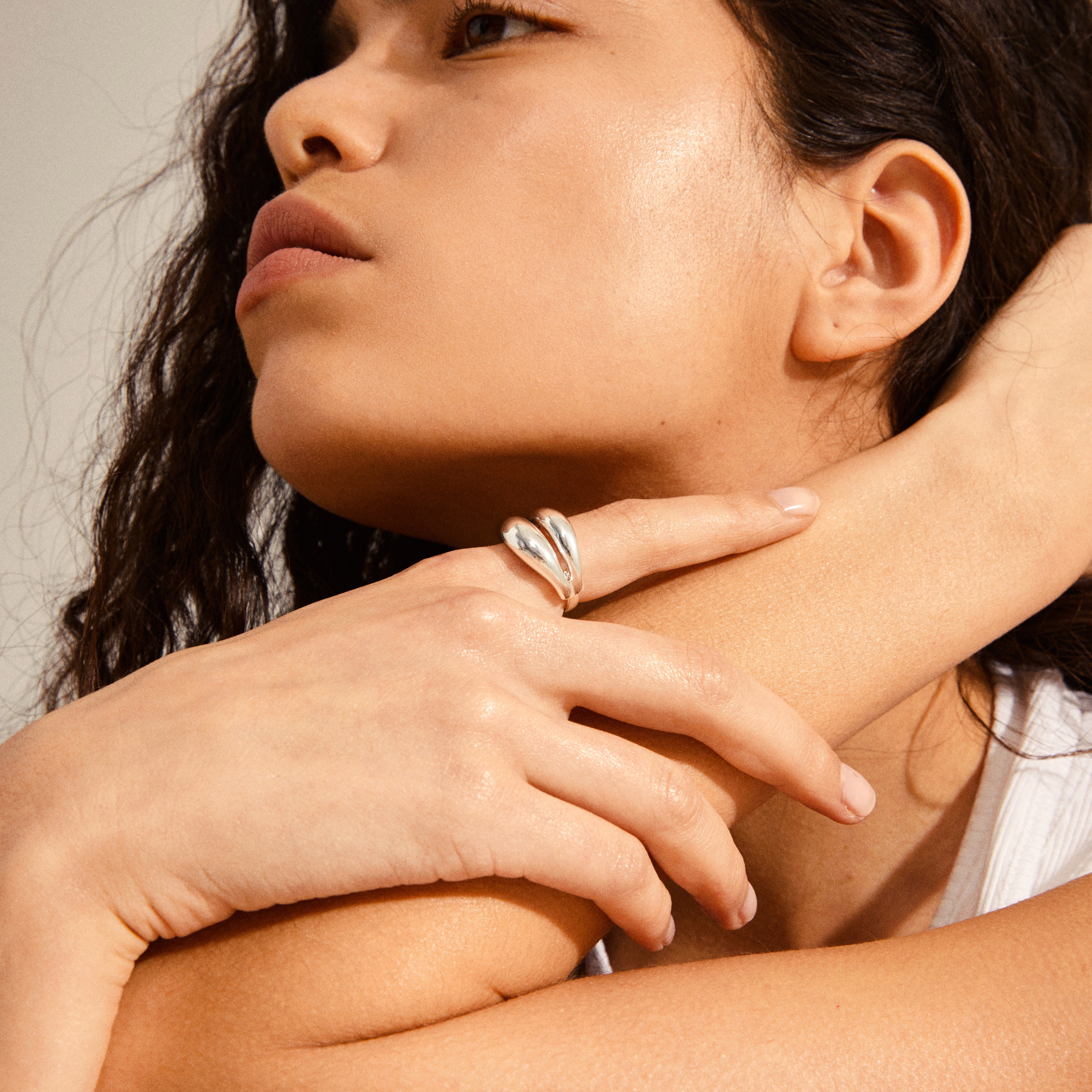 Close-up of a person showcasing Pilgrim's RECONNECT chunky statement ring, silver-plated, with a teardrop shape, highlighting its elegant, minimal design, and organic aesthetics.