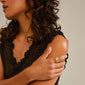 MOON ring gold-plated featuring an organic design with white beads, worn by a woman in a black dress, showcasing its unique and trendy style.