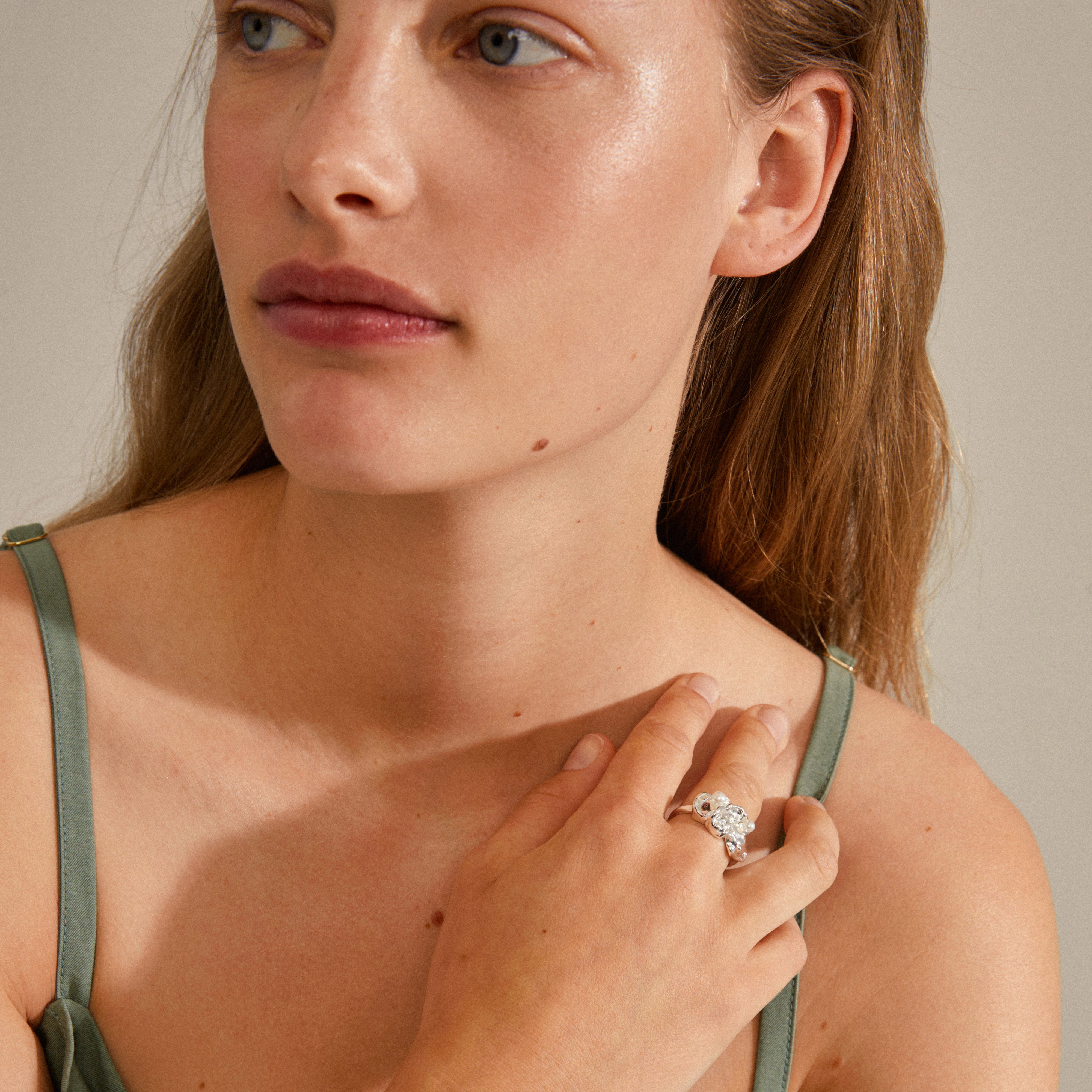 Close-up of a woman wearing the MOON ring, silver-plated with chunky design and tiny white beads, capturing Pilgrim's blend of adventure and style.