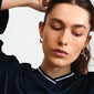 Woman wearing DUNE earrings silver-plated from Pilgrim's IMAGINATION collection, highlighting sleek, shiny hoops with a flattering shape and easy click clasps.