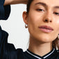 DUNE earrings silver-plated: Close-up of a woman wearing Pilgrim's silver-plated chunky hoop earrings, showcasing their sleek, shiny finish and elegant shape.