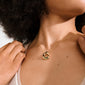 Close-up of a neck with Pilgrim's FREE gold-plated necklace, featuring a sculptural triangular pendant on a thin chain, highlighting natural elegance and personal style.