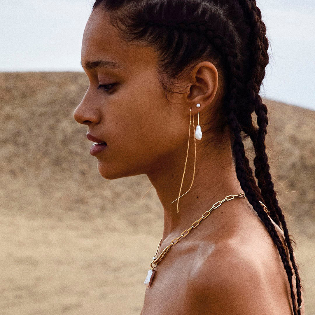 Close-up of a woman wearing Pilgrim's ENCHANTMENT gold-plated chain earrings, highlighting their stylish and timeless design.