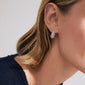Person wearing Pilgrim's FOCUS gold-plated crystal earrings with pavé-style teardrop design, showcasing sparkling stones and a sleek finish against short blonde hair.