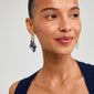 Close-up of a woman wearing Pilgrim's STARLIGHT silver-plated earrings, featuring chunky hoops with large pendants, highlighting her modern and trendy style.