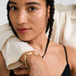 Young person with braids wearing Pilgrim's INSTANT gold-plated bracelet featuring flat rectangular links and textured finish, highlighting its chic, minimalist style.