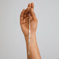 Hand holding the silver-plated INSTANT bracelet by Pilgrim, featuring flat, textured links reflecting light for a chic, effortless look. Perfect for minimalist or stacked styles.