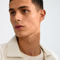 Young man wearing Pilgrim's INSTANT ear cuff, silver-plated with hammered texture, on his right ear, adds a stylish, minimalist touch to his look.