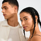 Two young adults wearing the silver-plated INSTANT ear cuffs by Pilgrim, showcasing a minimalist and fashion-forward style with a hammered texture and shiny finish.