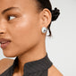 Young woman wears SPARKLE earrings silver-plated by Pilgrim, featuring a hammered finish that reflects light, conveying timeless appeal and eco-conscious elegance.