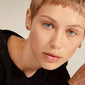 HORIZON earrings gold plated, worn by a woman with short blonde hair. Showcasing trendy ear curation with a mix-and-match style from Pilgrim's collection.
