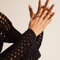 WILLPOWER sculptural ring gold-plated on a hand, showcasing its asymmetric, handcrafted design from Pilgrim's Willpower collection, highlighting its unique, nature-inspired shape.