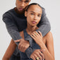 Man and woman displaying Pilgrim's gold-plated SEA ring, featuring a fossil-inspired motif, highlighting personal style and sustainability with 99% recycled material.