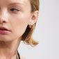 Gold-plated TRUST hoop earrings on a woman's ear, showcasing rustic, handcrafted design by Pilgrim, ideal for enhancing everyday style with organic charm.