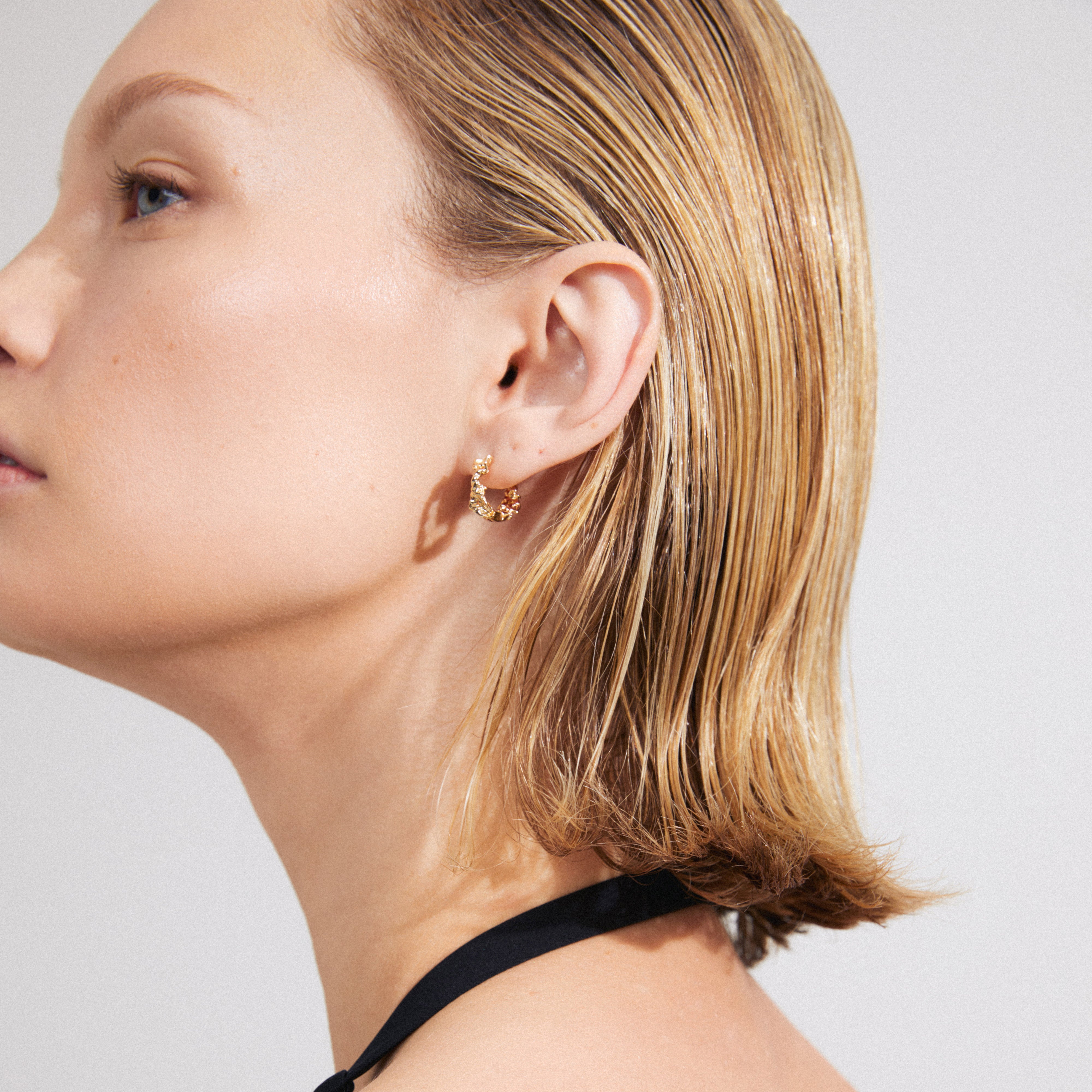TRUST hoop earrings gold-plated, featuring rustic, handcrafted charm with easy click clasp, perfect for enhancing everyday style. Elevate your look mindfully with 99% recycled materials.
