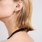 Side-profile of a person wearing Pilgrim's TRUST gold-plated hoop earrings, showcasing their textured, rustic design and artisan craftsmanship, perfect for everyday wear.