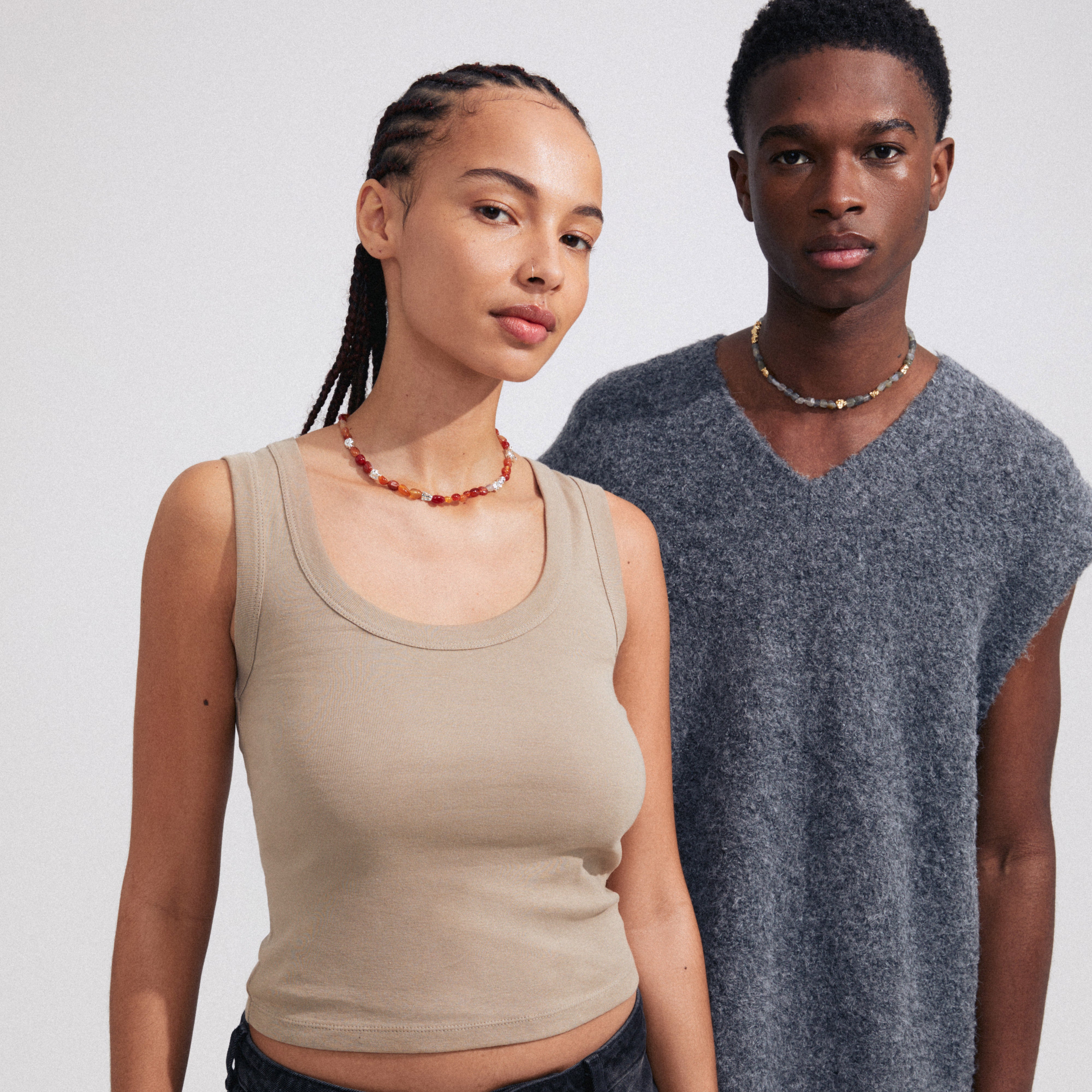 TRUST necklace silver-plated, worn by a woman with braids, features red Agate and silver-plated details, styled with a decorative T-bar clasp for a boho look.