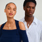 ECLIPSE necklace gold-plated on a woman, showcasing its organic leaf pendant and slim curb chain, embodies Pilgrim's handcrafted essence and urban edge.