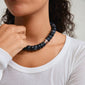 ECLIPSE necklace grey/gold-plated showcased on a woman, featuring chunky dark grey recycled acrylic beads, embodying Pilgrim's trendy, inclusive style.