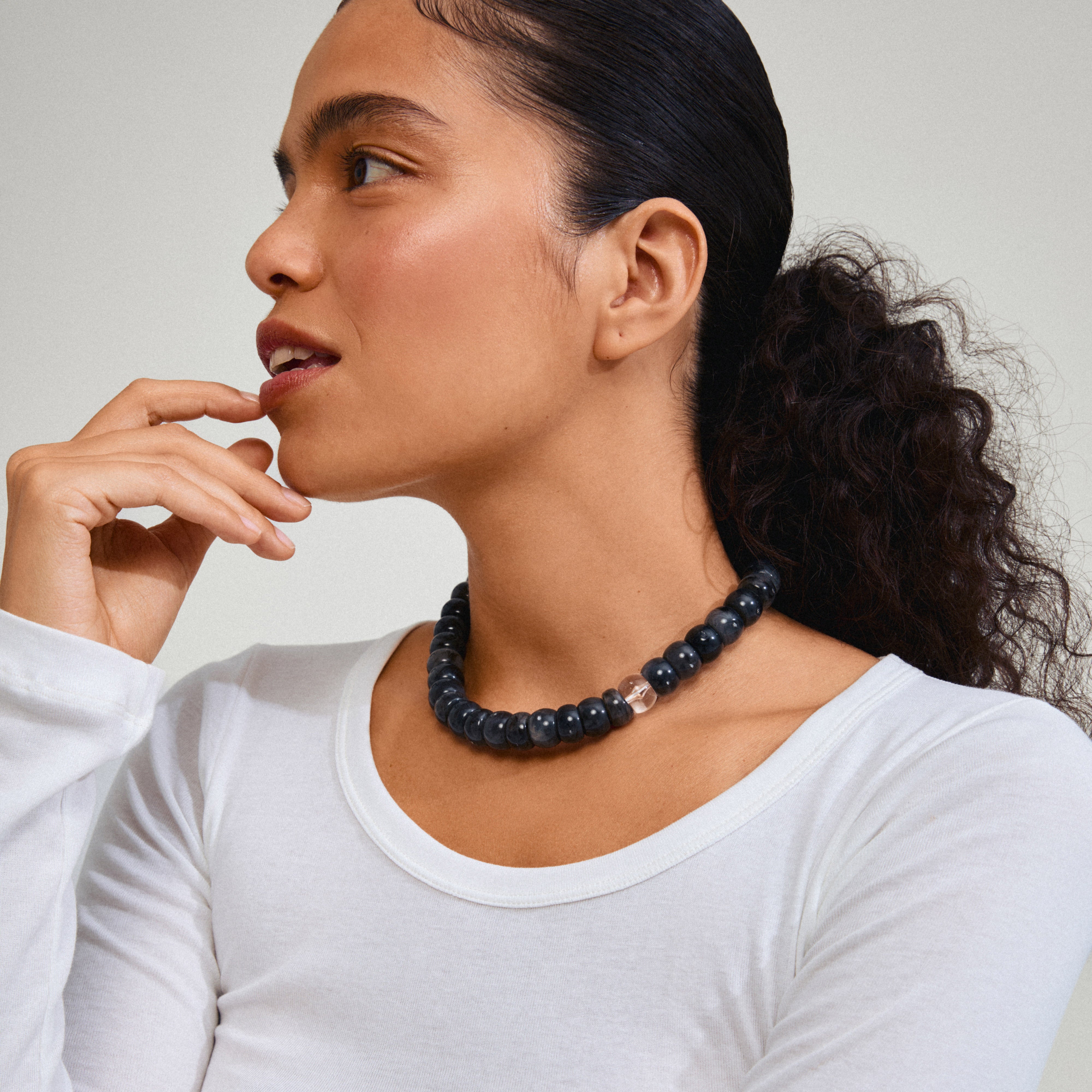 ECLIPSE necklace grey/gold-plated on woman’s neck, featuring chunky recycled acrylic beads with gold-plated extension, embodying Pilgrim’s effortless and versatile style.