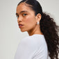 Close-up of Pilgrim's ECLIPSE silver-plated hoops, showcasing their organic design and artisanal touch in a woman's ear, highlighting a nature-inspired style.