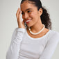 ECLIPSE necklace white/silver-plated showcased on a smiling woman, featuring chunky ivory beads, reflecting Pilgrim's blend of timeless and trendy Scandinavian style.