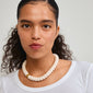Woman wearing ECLIPSE necklace with chunky ivory acrylic beads, showcasing a versatile style from Pilgrim's nature-inspired jewelry collection.
