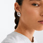 Young woman wearing a silver-plated UNFOLD earring by Pilgrim, featuring a sculptural spiral design, showcasing artistic expression and eco-friendly craftsmanship.