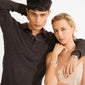 Young man and woman model the silver-plated SHIFT bracelet from Pilgrim, showcasing its raw, textured coins and boho chic, sophisticated design.