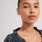 Close-up of a woman wearing FORCE earrings, 2-in-1 set, silver-plated, featuring ocean-inspired motifs, emphasizing sustainable fashion from Pilgrim.
