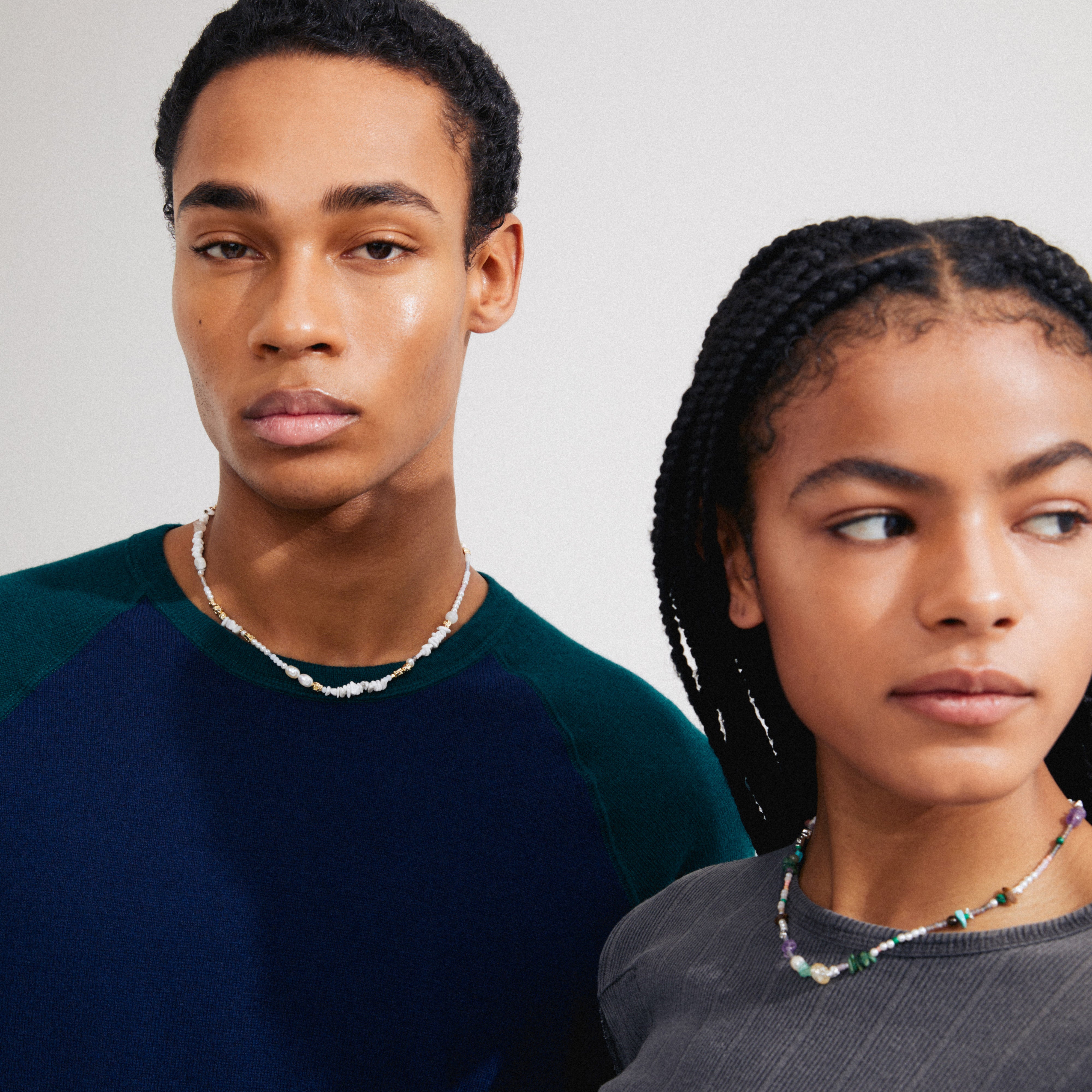 FORCE necklace multi/silver-plated, worn by a man and woman, features genuine freshwater pearls and semi-precious stones, embodying Pilgrim's Scandinavian quality and summer festival vibe.