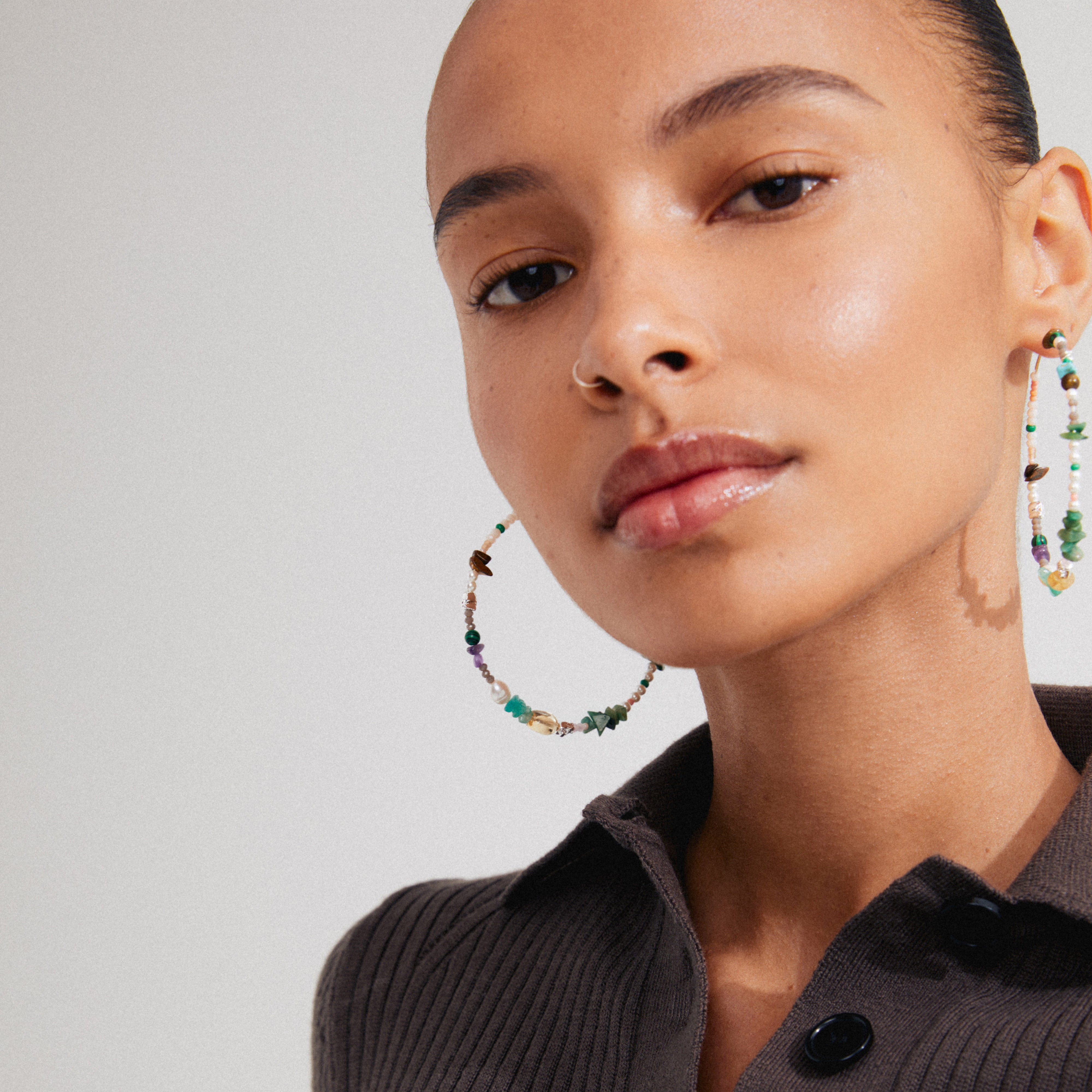 FORCE mega hoop earrings featuring semi-precious stones and silver-plated details, worn by a woman, embodying Pilgrim's blend of trendy, Scandinavian-inspired jewelry.