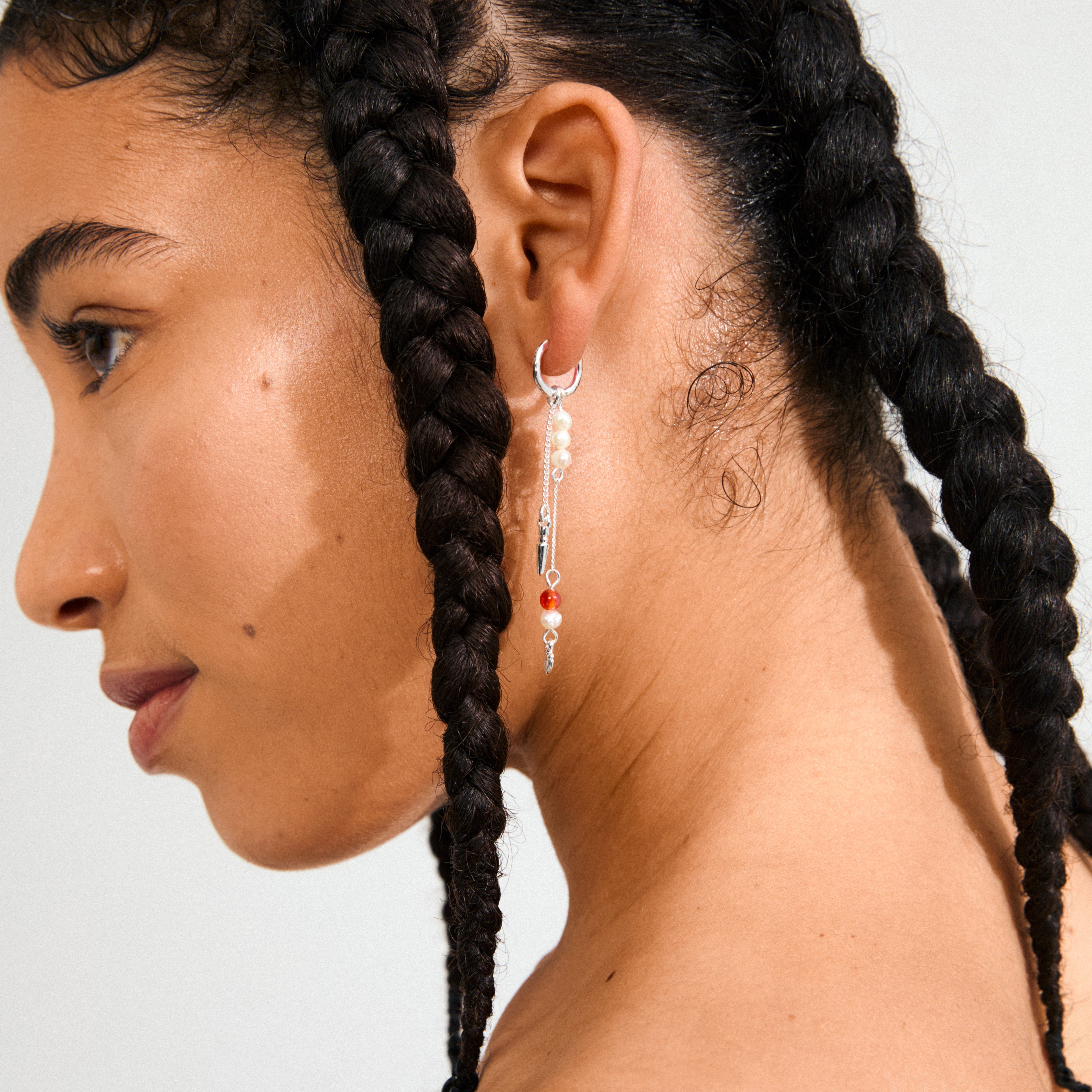 Silver-plated BETWEEN chain earrings with asymmetrical hoop design, featuring Amethyst, Aventurine, Tiger Eye, and freshwater pearl pendants for a bohemian look.