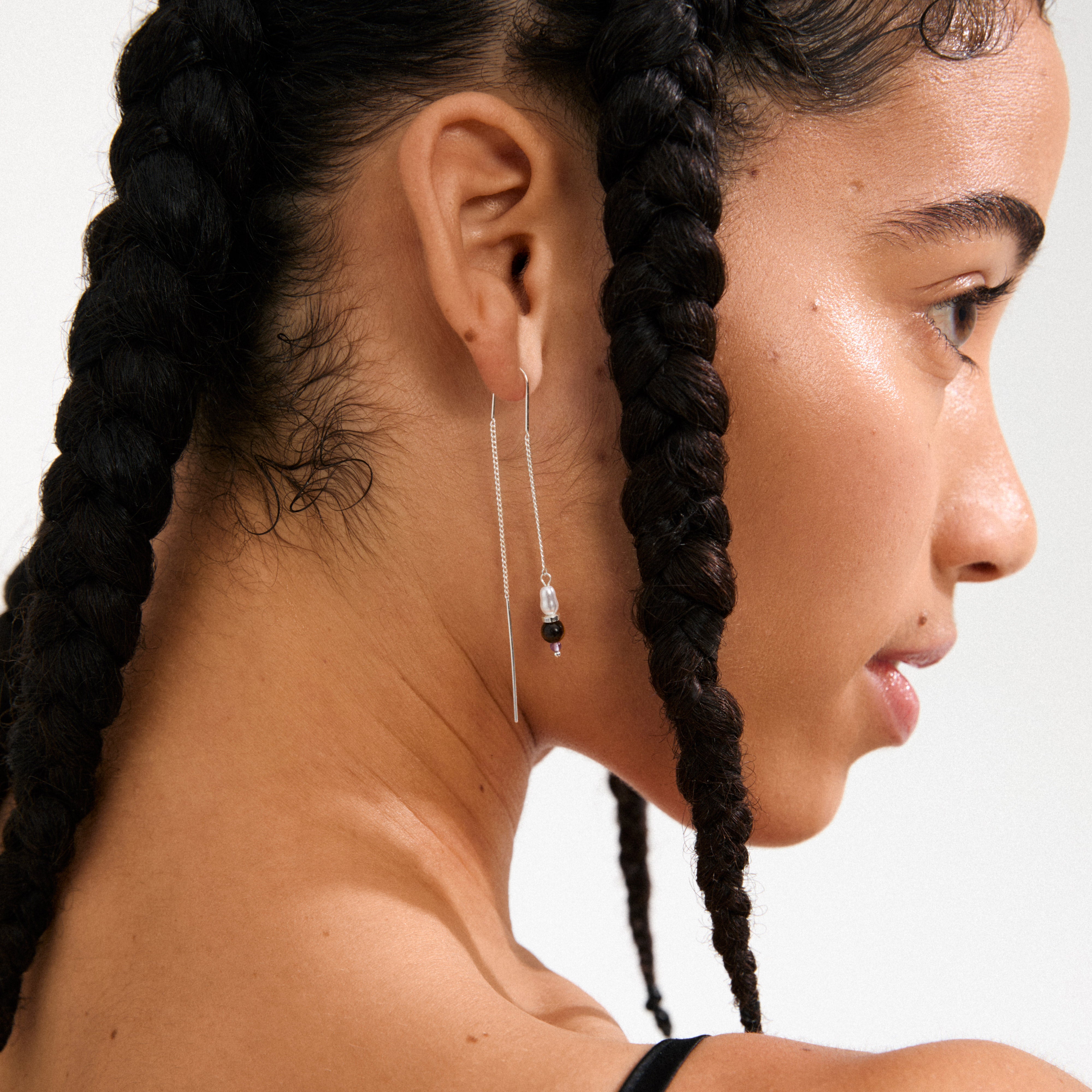 BETWEEN chain earrings silver-plated, featuring asymmetrical hoop and chain design with pendants of amethyst, aventurine, tiger eye, and freshwater pearls.