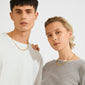 Two models showcasing Pilgrim's SENSE gold-plated necklace, featuring square coins with a raw texture, reflecting light for a stylish glow.