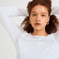 Young person wearing Pilgrim's SENSE hoop earrings, silver-plated with a wavy design, showcasing a minimal, stylish look against a light background.