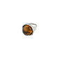 Silver-tone SENSE ring by Pilgrim, featuring a round tiger’s-eye stone in an organic bezel, embodying strength and style with an adjustable band.