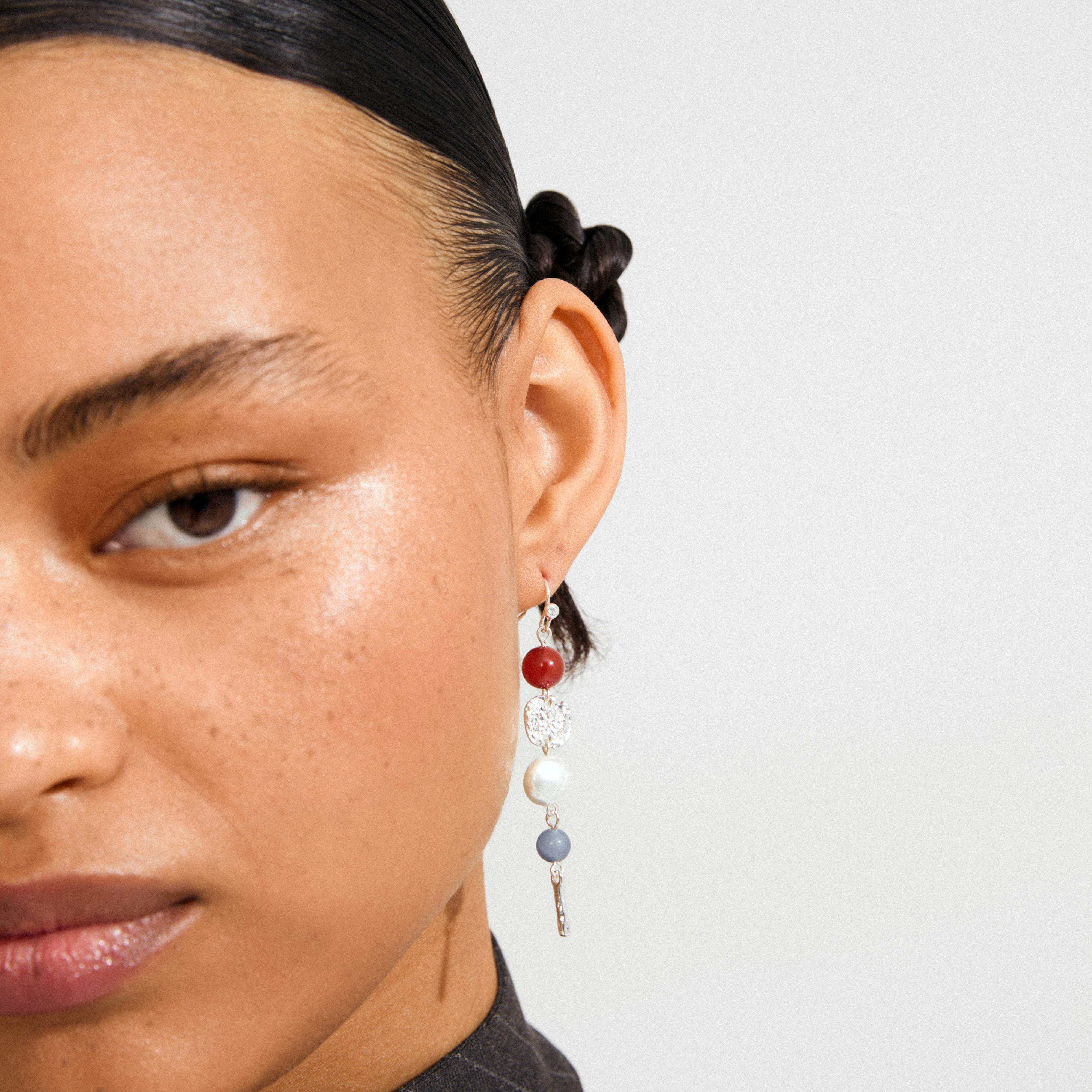 SENSE earrings silver-plated/multi feature a long, multi-bead design with red, clear, pearl, and gray beads, offering a boho luxe vibe.