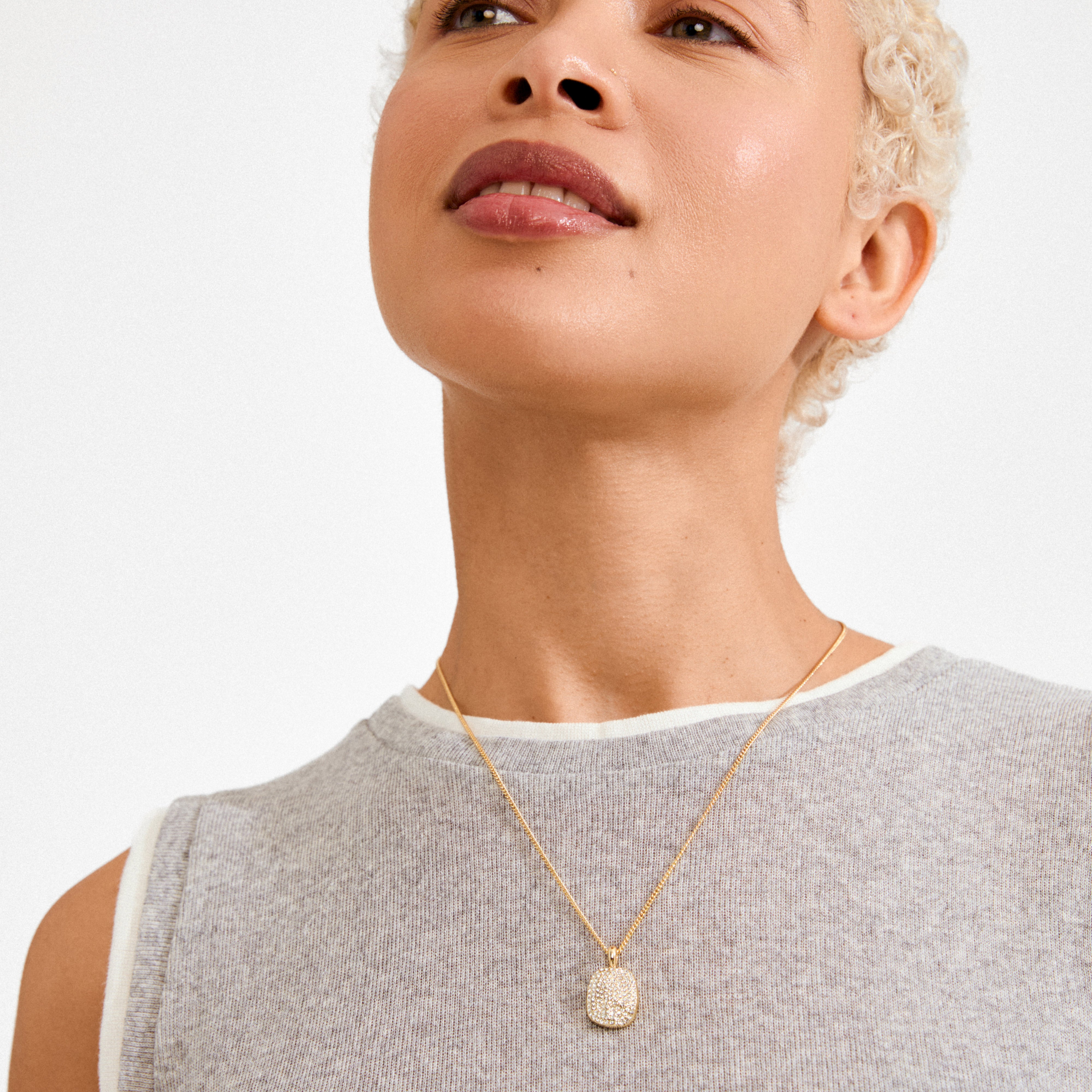 EMBER necklace gold-plated on model, featuring a pavé encrusted pendant on a fine chain, highlighting Pilgrim's Nordic-inspired, recycled jewelry craftsmanship.