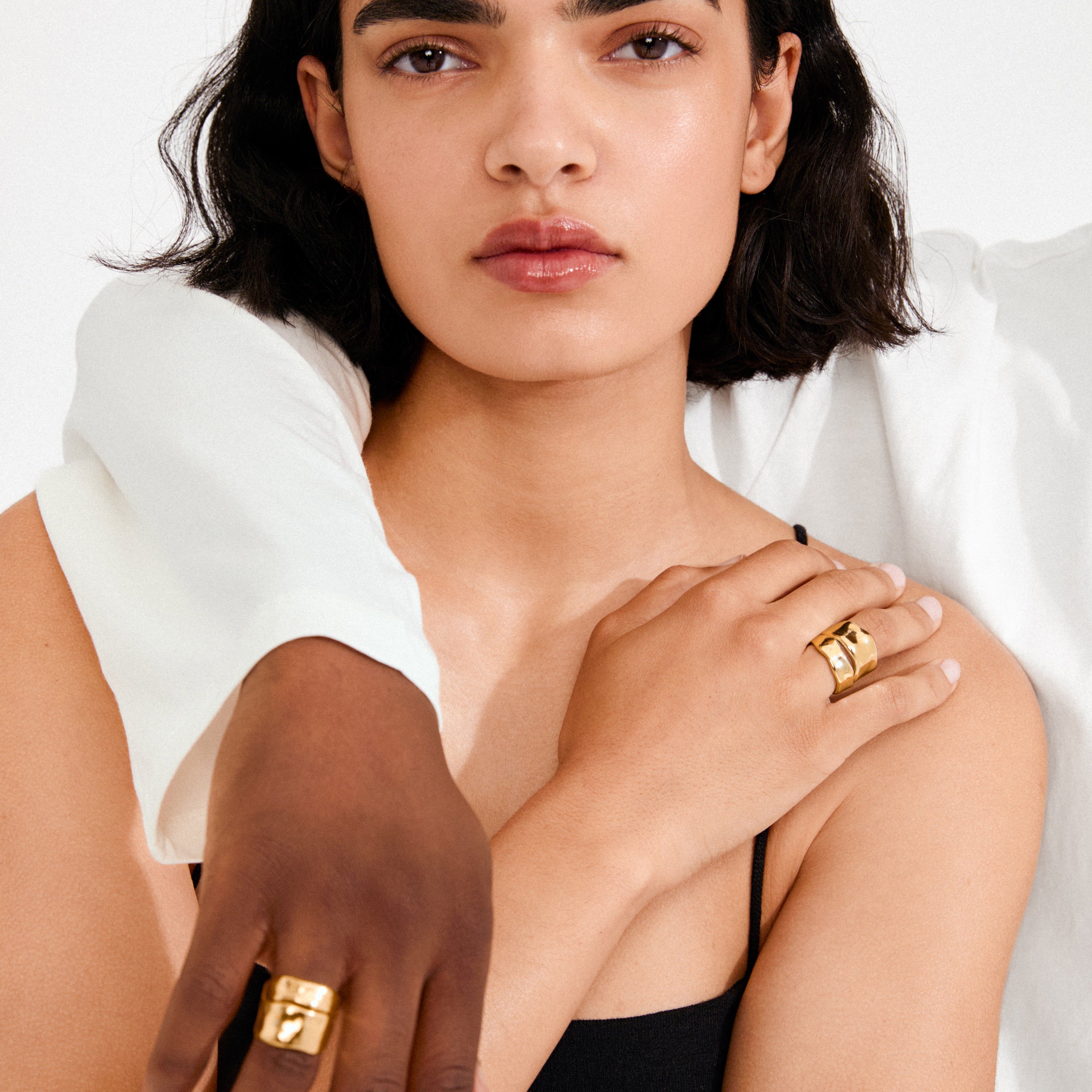 Two people showcase the EMBER rings 2-in-1 set, gold-plated, featuring bold, sculptural designs on their hands, highlighting Pilgrim's handcrafted elegance and contemporary style.