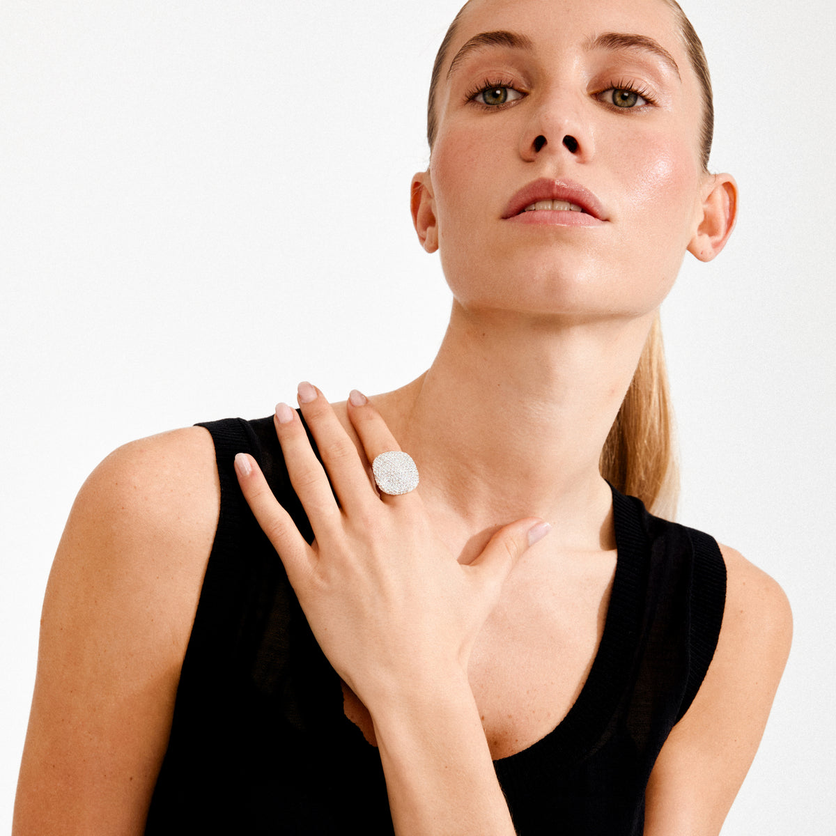 Woman showcasing the EMBER ring silver-plated by Pilgrim, featuring a bold, square pavé-style design encrusted with sparkling Preciosa crystals.