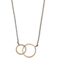 HARPER gold-plated necklace featuring two intertwined rings as a pendant, symbolizing connection. Stylish and adjustable, it embodies Pilgrim's timeless Scandinavian design.