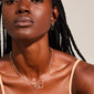 Close-up of a woman wearing the HARPER necklace, featuring two intertwined silver-plated rings, symbolizing connection and unity.