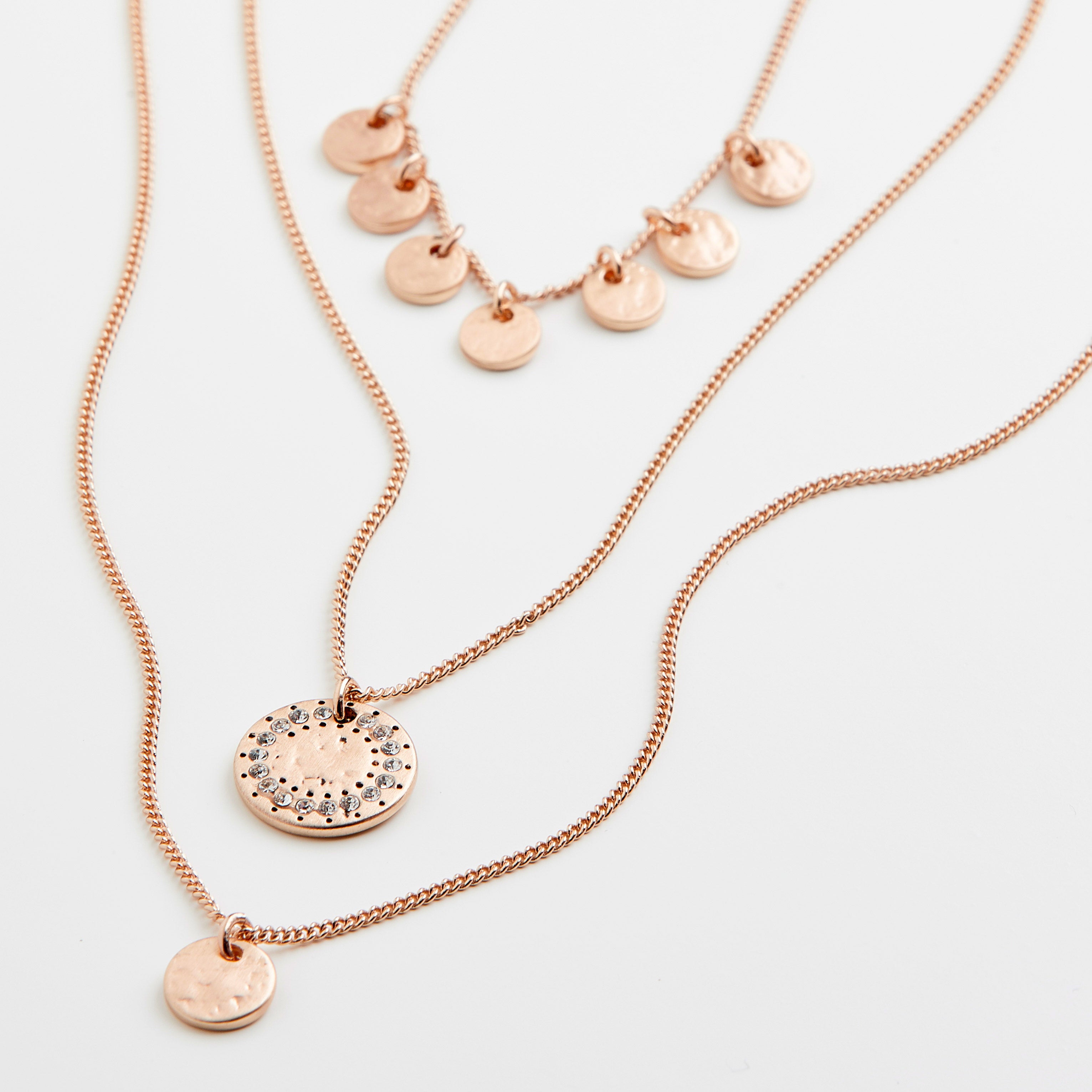ARDEN 3-in-1 crystal necklace in rose-gold, featuring three layered chains with hammered disc charms and a crystal-bordered pendant, offering a feminine and ethnic-inspired design.